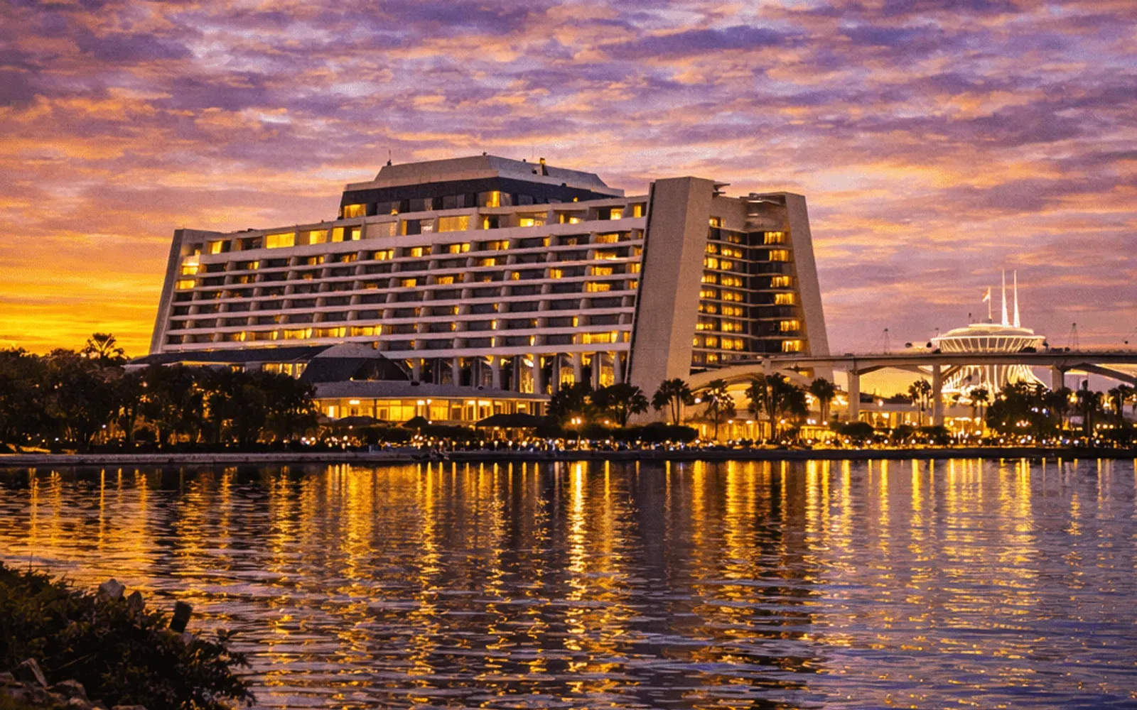 Illustrated sunset view of Disney's Contemporary Resort across the water.