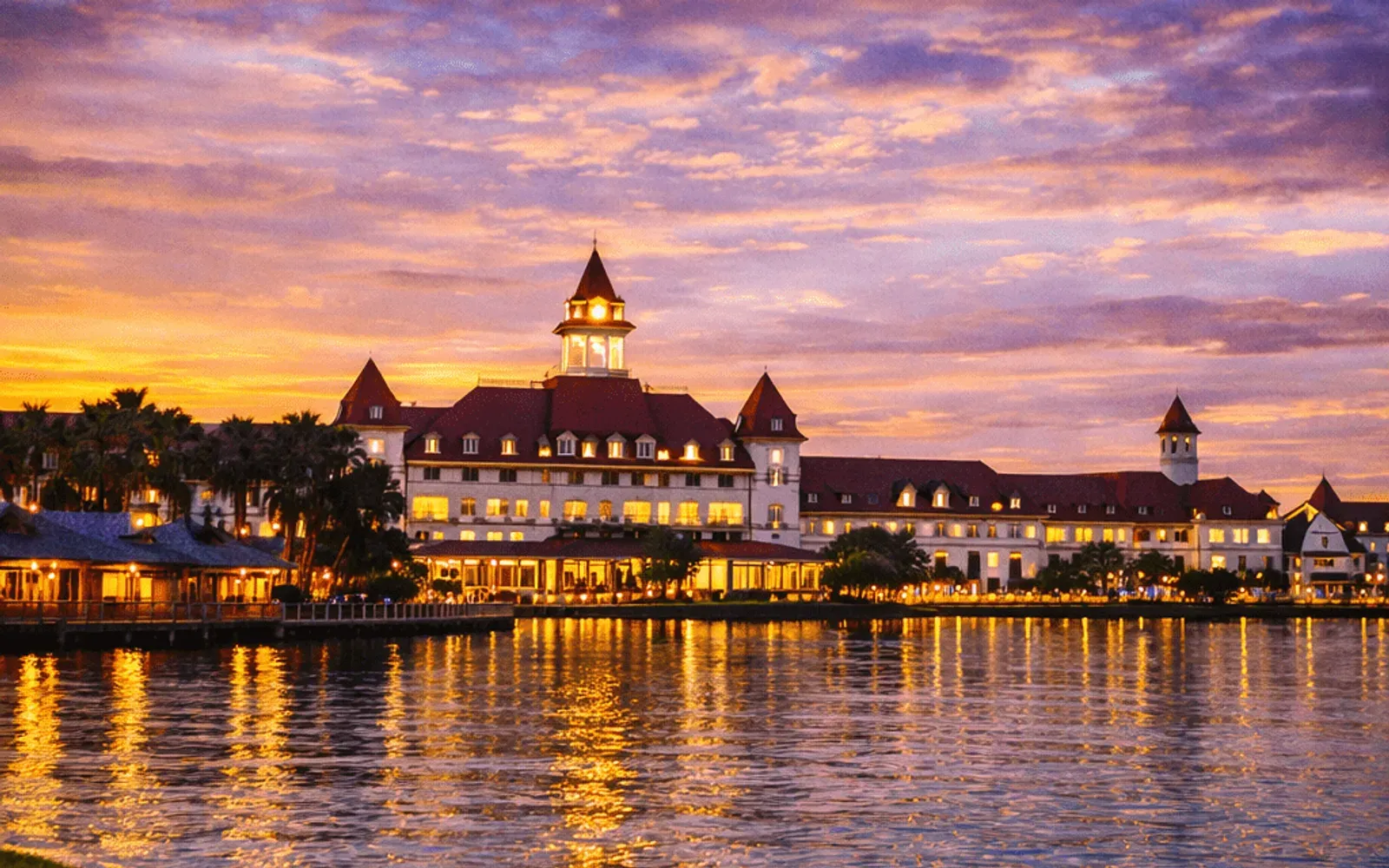 Illustrated sunset view of Disney's Grand Floridian Resort & Spa across the water.