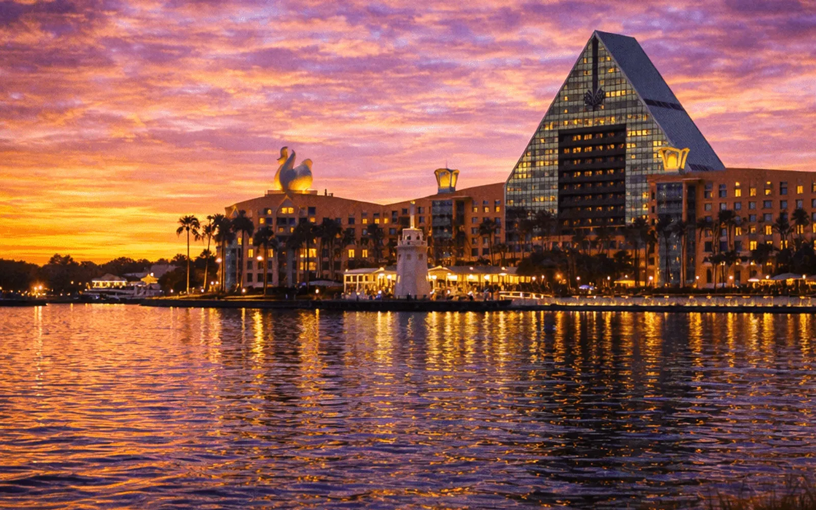 Illustrated sunset view of Walt Disney World Swan & Dolphin across the water.